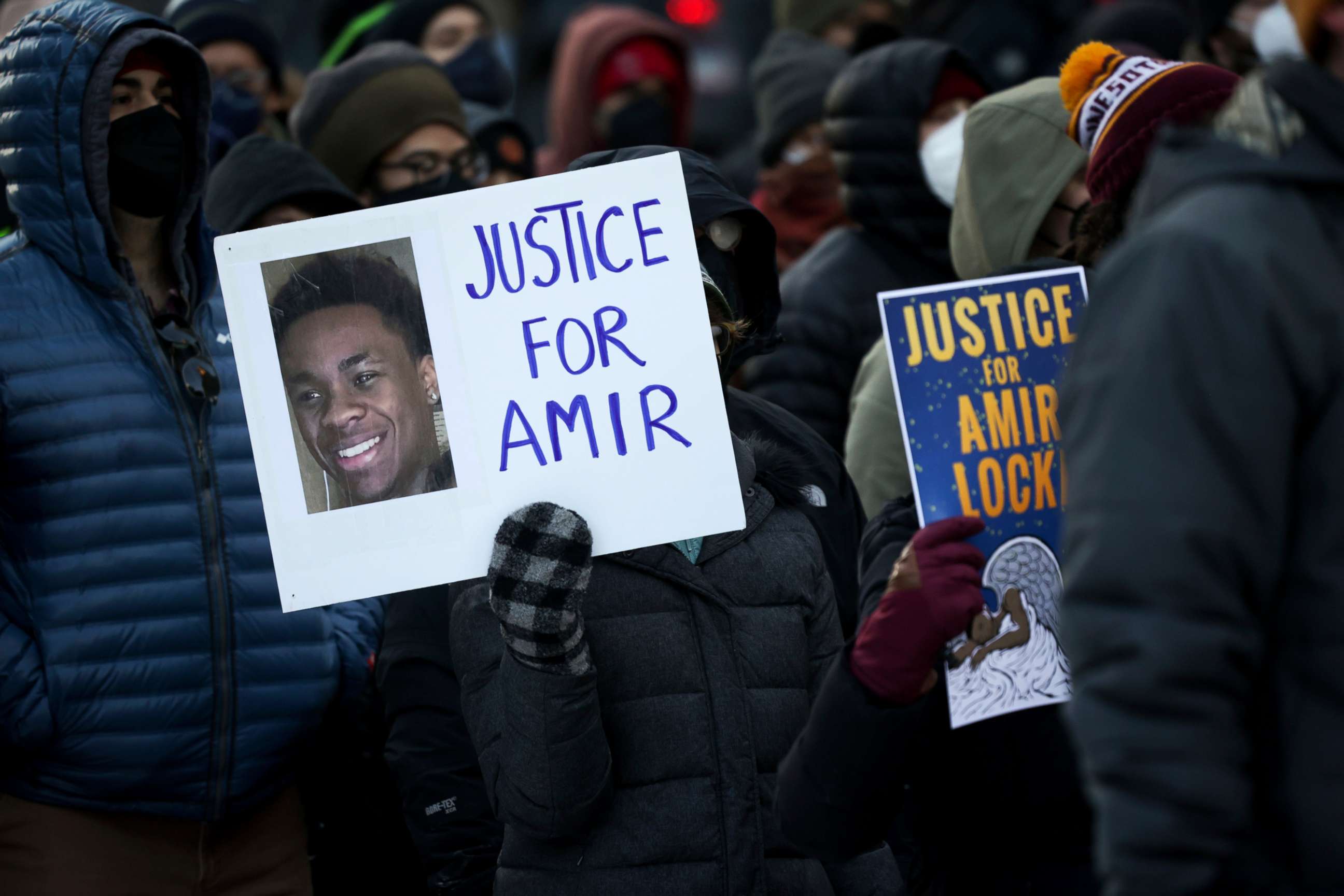 PHOTO: A protester holds a sign demanding justice for Amir Locke, who was killed during a no-knock warrrant, at a rally, Feb. 5, 2022, in Minneapolis.