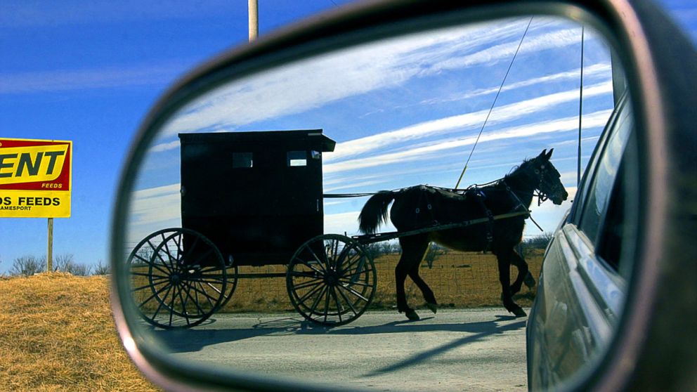 An Amish horse and buggy travel along the country roads leaving the small town of Jamesport, Mo., Feb. 12, 2002.
