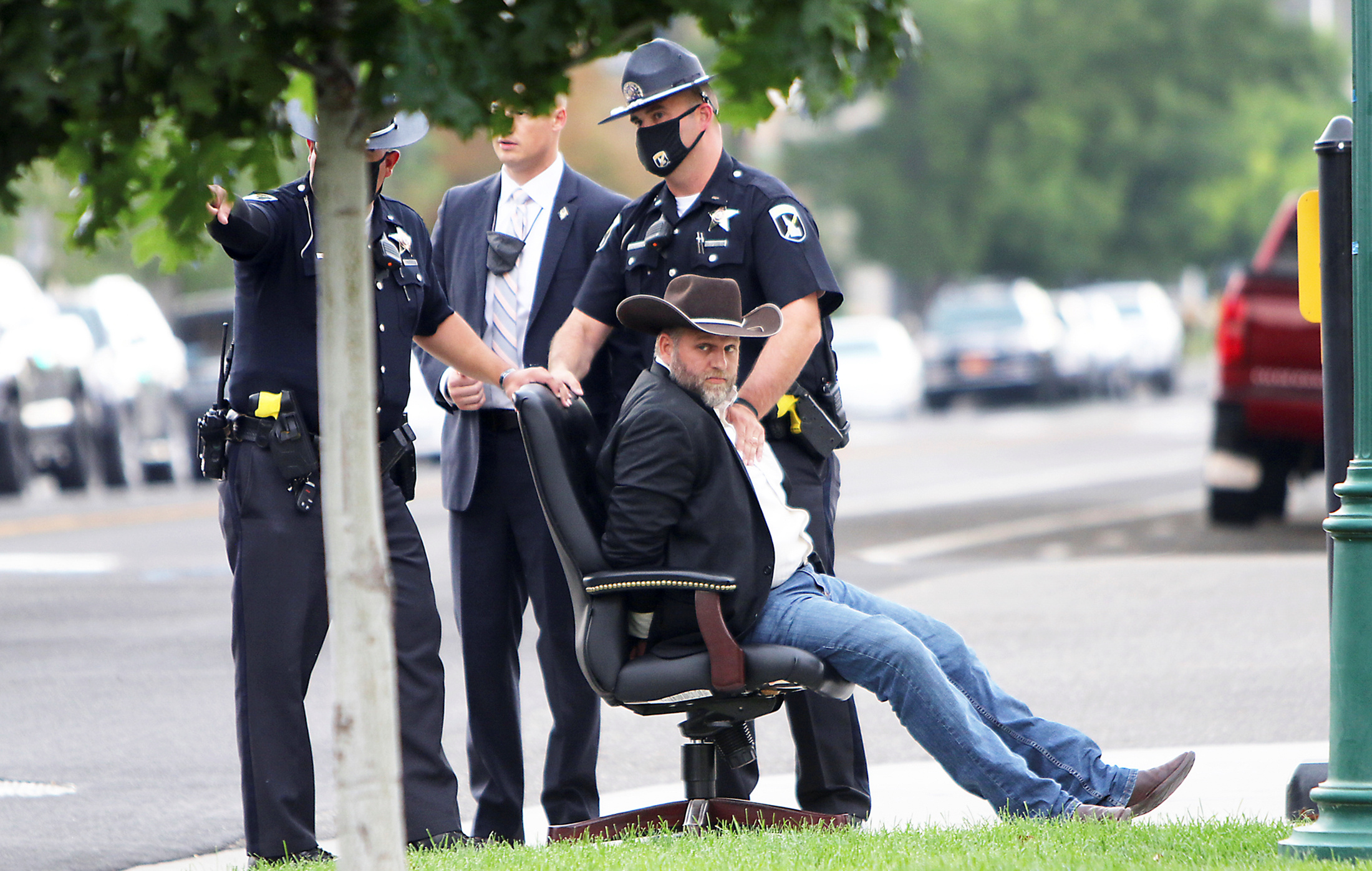 PHOTO: Idaho State troopers take Ammon Bundy toward a waiting patrol car after he was arrested for trespassing at a special legislative session being held in regard to the coronavirus pandemic at the Idaho State Capital in Boise, Idaho, Aug. 25, 2020. 