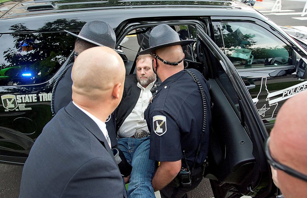 PHOTO: Idaho State troopers place Ammon Bundy in a waiting patrol car after he was arrested for trespassing at a special legislative session at the Idaho State Capital in Boise, Idaho, Aug. 25, 2020.