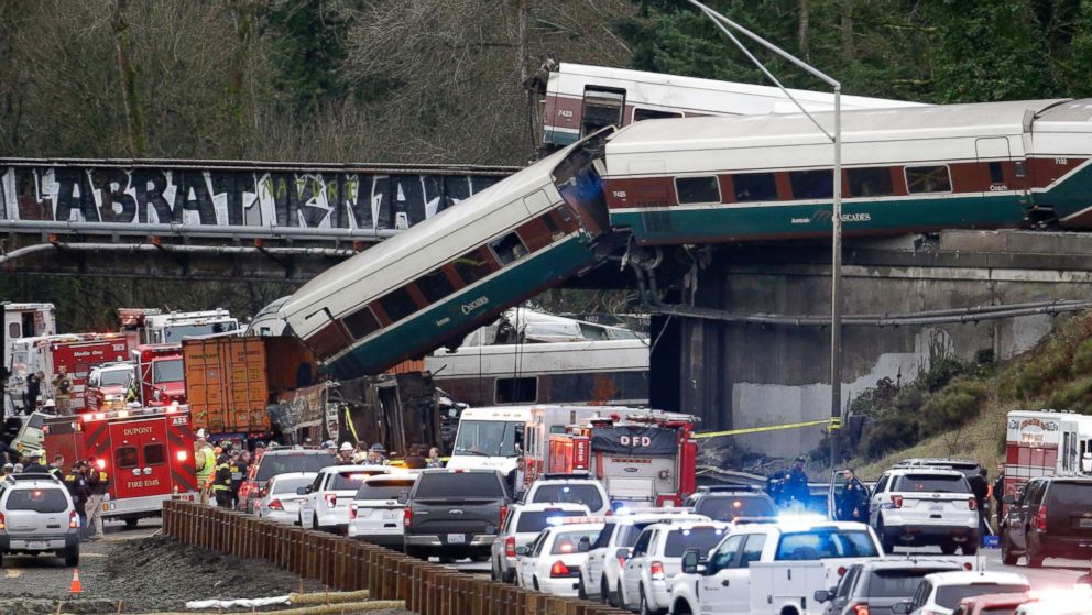 PHOTO: Cars from an Amtrak train lay spilled onto Interstate 5 below as some remain on the tracks above, Dec. 18, 2017, in DuPont, Wash.