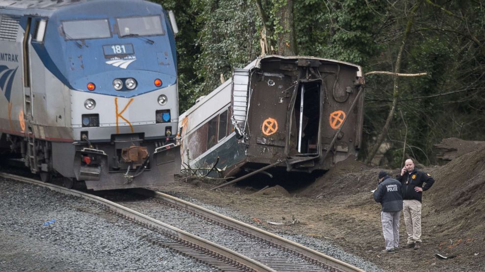 Investigators work at the scene of a Amtrak train derailment on Dec. 18, 2017 in DuPont, Wash.