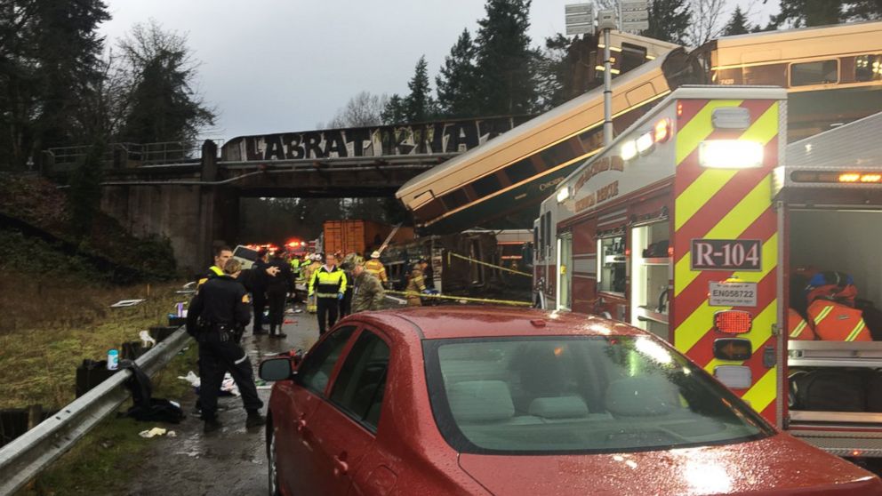 Emergency crews respond to the scene of a train derailment over Interstate 5 in Washington state, Dec. 18, 2017.