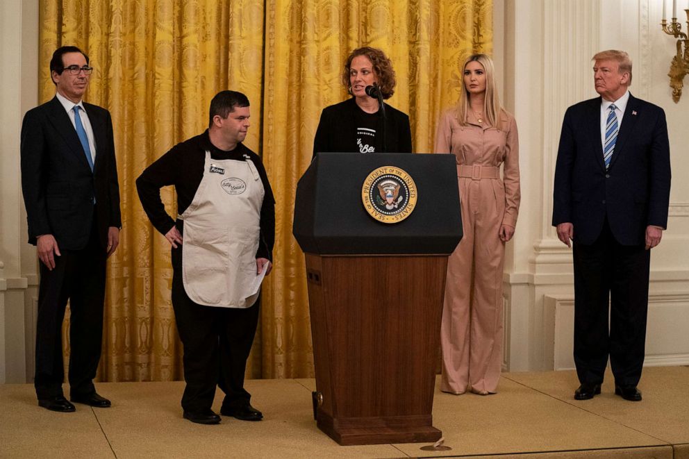 PHOTO: In this April 28, 2020, file photo, President Donald Trump listens as CEO and founder of Bitty & Beau's Coffee Shop Amy Wright speaks during an event about the Paycheck Protection Program at the White House in Washington.