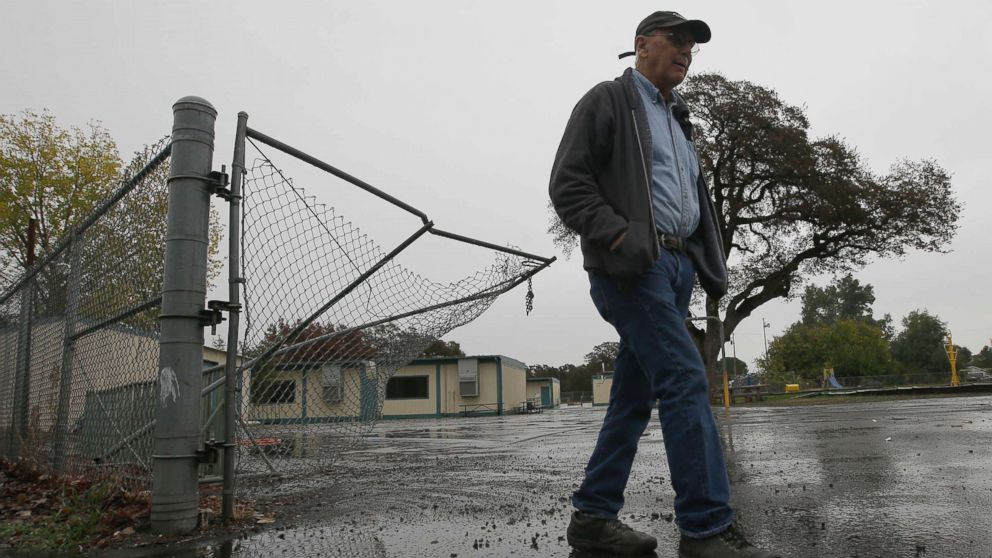 PHOTO: Randy Morehouse, the maintenance and operations supervisor for the Corning Elementary School District, walks past the gate that gunman Kevin Janson Neal crashed through during his shooting rampage at Rancho Tehama Elementary School, Nov. 15, 2017.