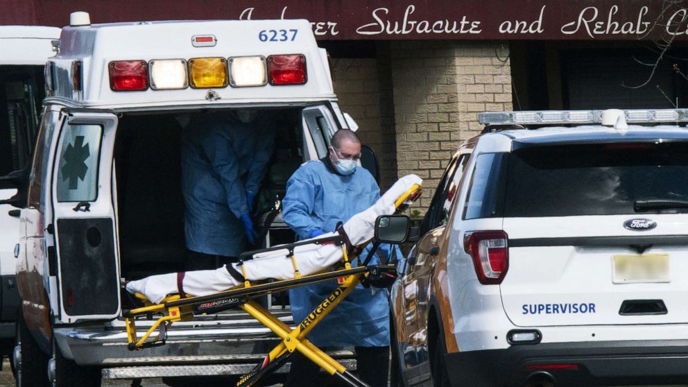PHOTO: Medical workers prepare to transport a patient from Andover Subacute and Rehabilitation Center while wearing masks and personal protective equipment (PPE),  April 16, 2020 in Andover, New Jersey.
