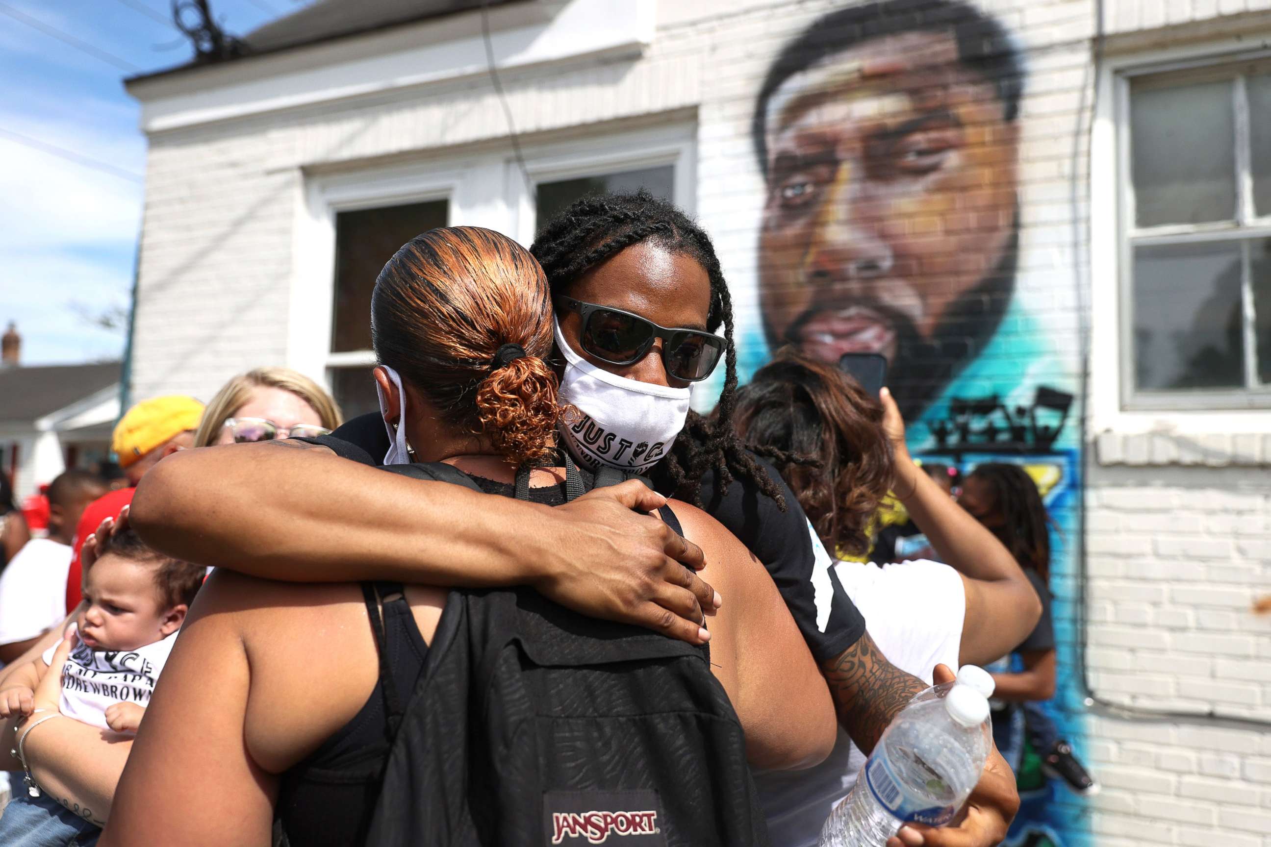 PHOTO: Khalil Ferebee, son of Andrew Brown Jr., receives a hug as people gather on May 2, 2021 in Elizabeth City, N.C., in protest after Mr. Brown's death.