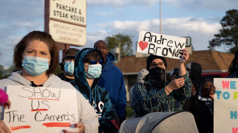 PHOTO: Demonstrators hold signs while participating in a protest march on April 22, 2021, in Elizabeth City, N.C. The protest was sparked by the police killing of Andrew Brown Jr. on April 21.