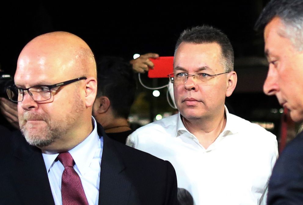 PHOTO: Pastor Andrew Brunson, center, and U.S. Charge d'Affaires Jeffrey Hovenier, left, arrive at Adnan Menderes airport for a flight to Germany after his release following his trial in Izmir, Turkey, Oct. 12, 2018.