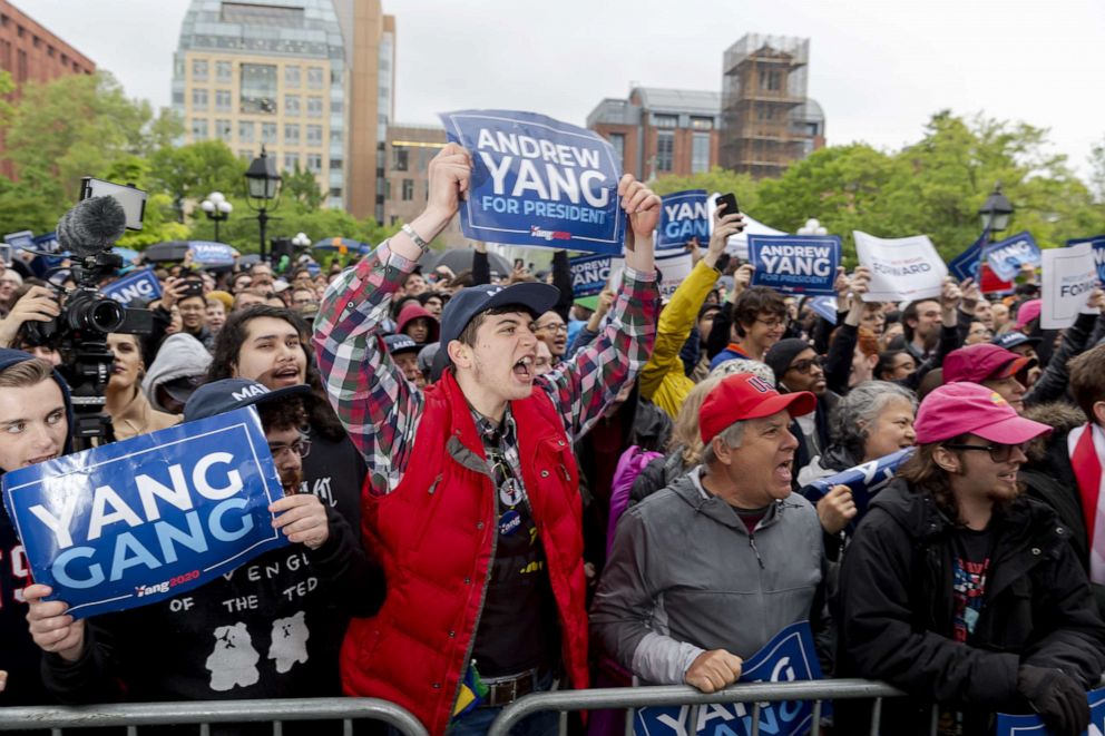 PHOTO: Attendees hold signs and shout slogans during a campaign rally for 2020 Democratic presidential candidate Andrew Yang, in New York, May 14, 2019.