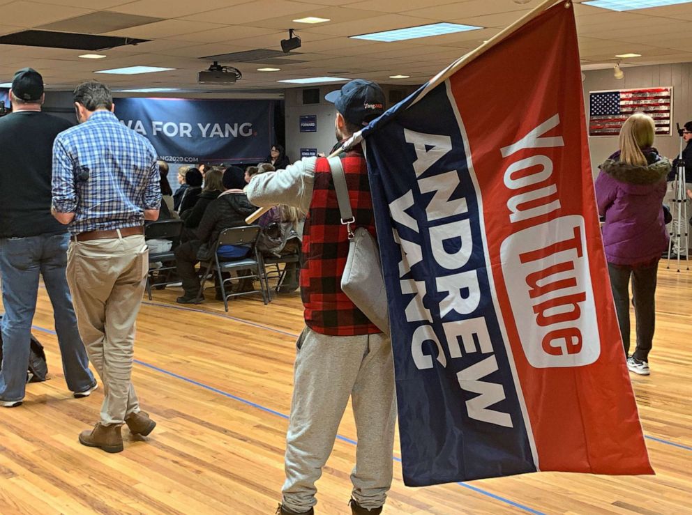 PHOTO: Caption: An Andrew Yang supporter holds a flag during a town hall in Newton, Iowa, Jan. 13, 2020. CREDIT Armando Garcia/ABC News