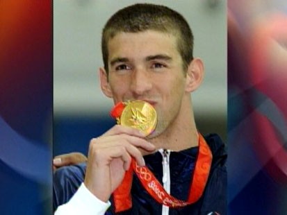 Picture of Michael Phelps with the gold medal.