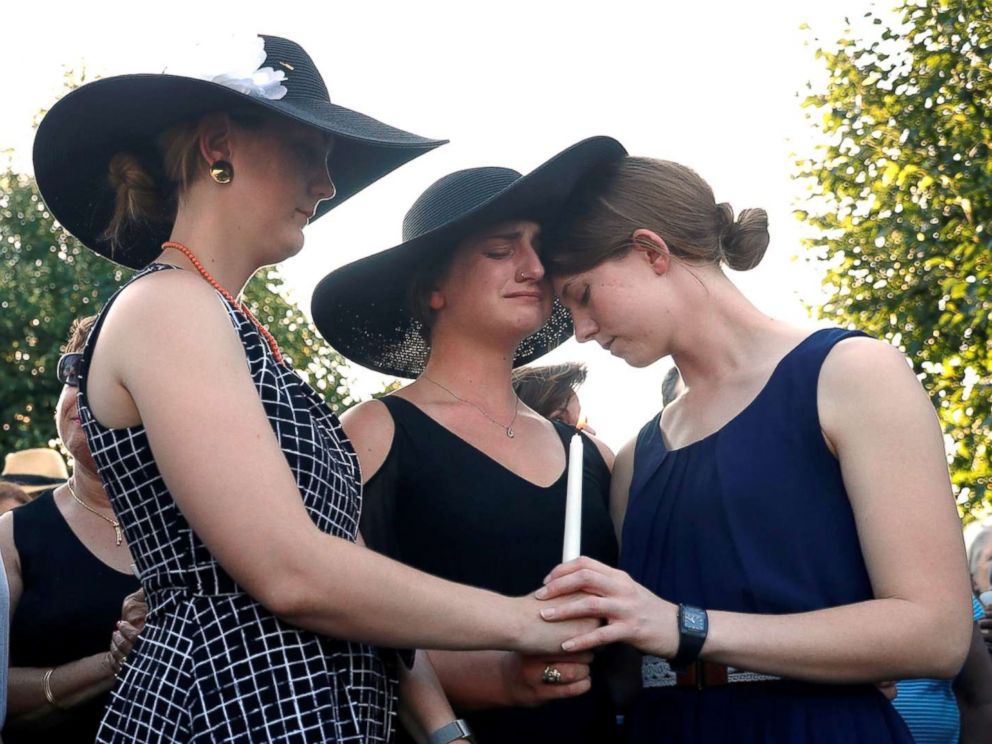 PHOTO: Three daughters of Wendi Winters, Winters, Summerleigh and Montana Geimer hold each other during a candlelight vigil held near the Capital Gazette in Annapolis, Md., June 29, 2018.