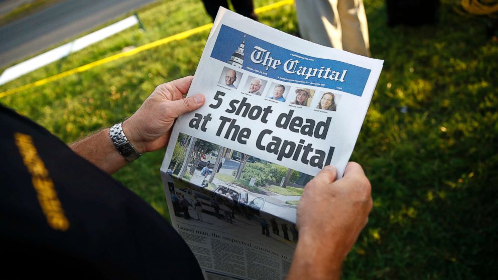 PHOTO: Steve Schuh, county executive of Anne Arundel County, holds a copy of The Capital Gazette near the scene of a shooting at the newspaper's office, June 29, 2018, in Annapolis, Md.
