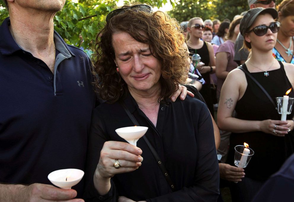 PHOTO: People gather for a candlelight vigil across the street from where five journalists were slain in their newsroom in Annapolis, Md., June 29, 2018.