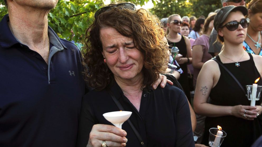 People gather for a candlelight vigil across the street from where five journalists were slain in their newsroom in Annapolis, Md., on June 29, 2018.