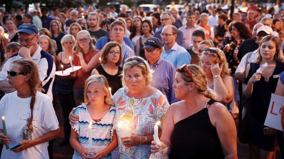 Mourners stand in silence during a vigil in response to a shooting at the Capital Gazette newsroom on June 29, 2018, in Annapolis, Md.