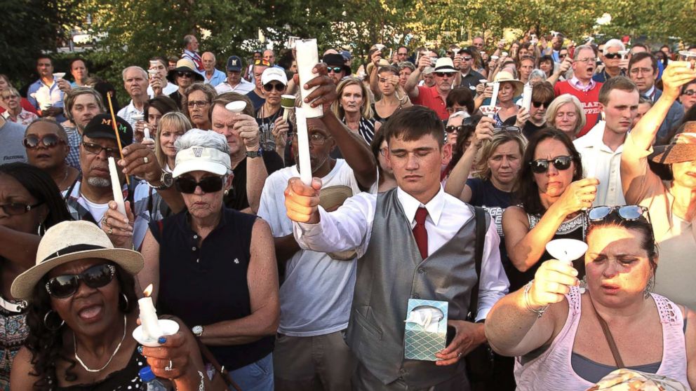 Residents gather for a candlelight vigil across the street from where five journalists were slain at their newspaper office in Annapolis, Md., June 29, 2018.