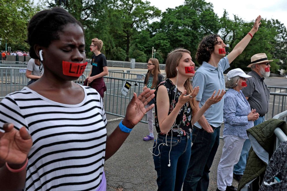 PHOTO: Anti-abortion protesters pray as they await decision announcements in front of the U.S. Supreme Court Building on May 16, 2022 in Washington. The Court issued decisions for Patel v. Garland and Federal Election Commission v. Ted Cruz for Senate. 