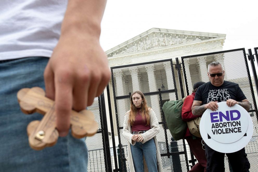 PHOTO: People pray outside the U.S. Supreme Court on May 5, 2022 in Washington, D.C. as protestors on both sides of the abortion debate continue to demonstrate following the leaked draft of the Court's potential decision to overturn Roe v. Wade. 