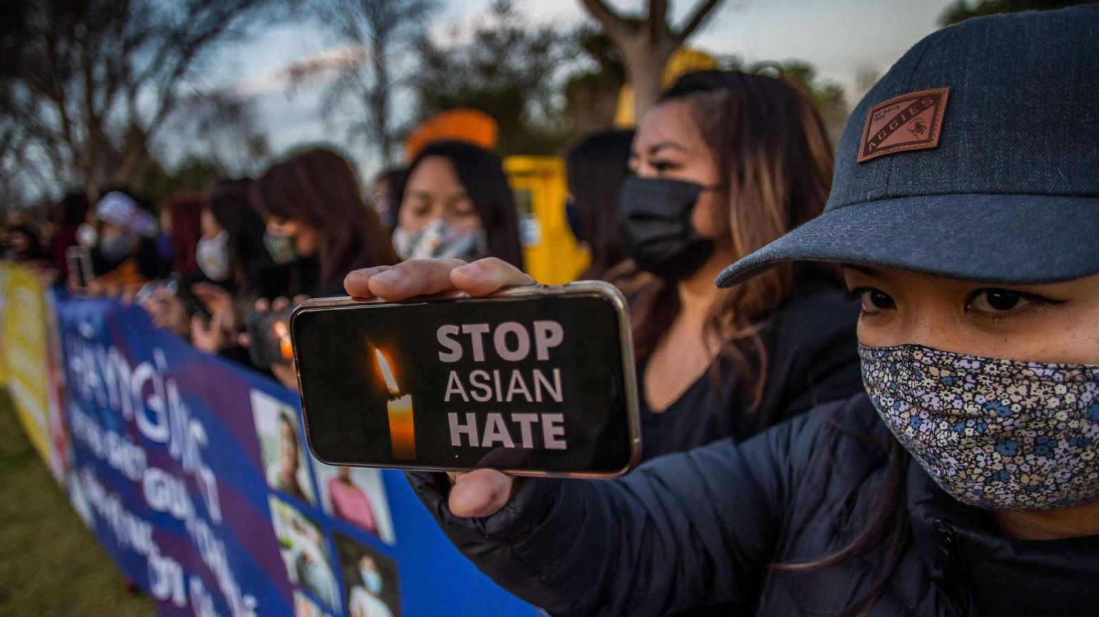 PHOTO: Julie Tran holds her phone during a candlelight vigil in Garden Grove, Calif., March 17, 2021, in response to the Atlanta shootings on March 16 and other instances of violence across the country targeting people of Asian descent.