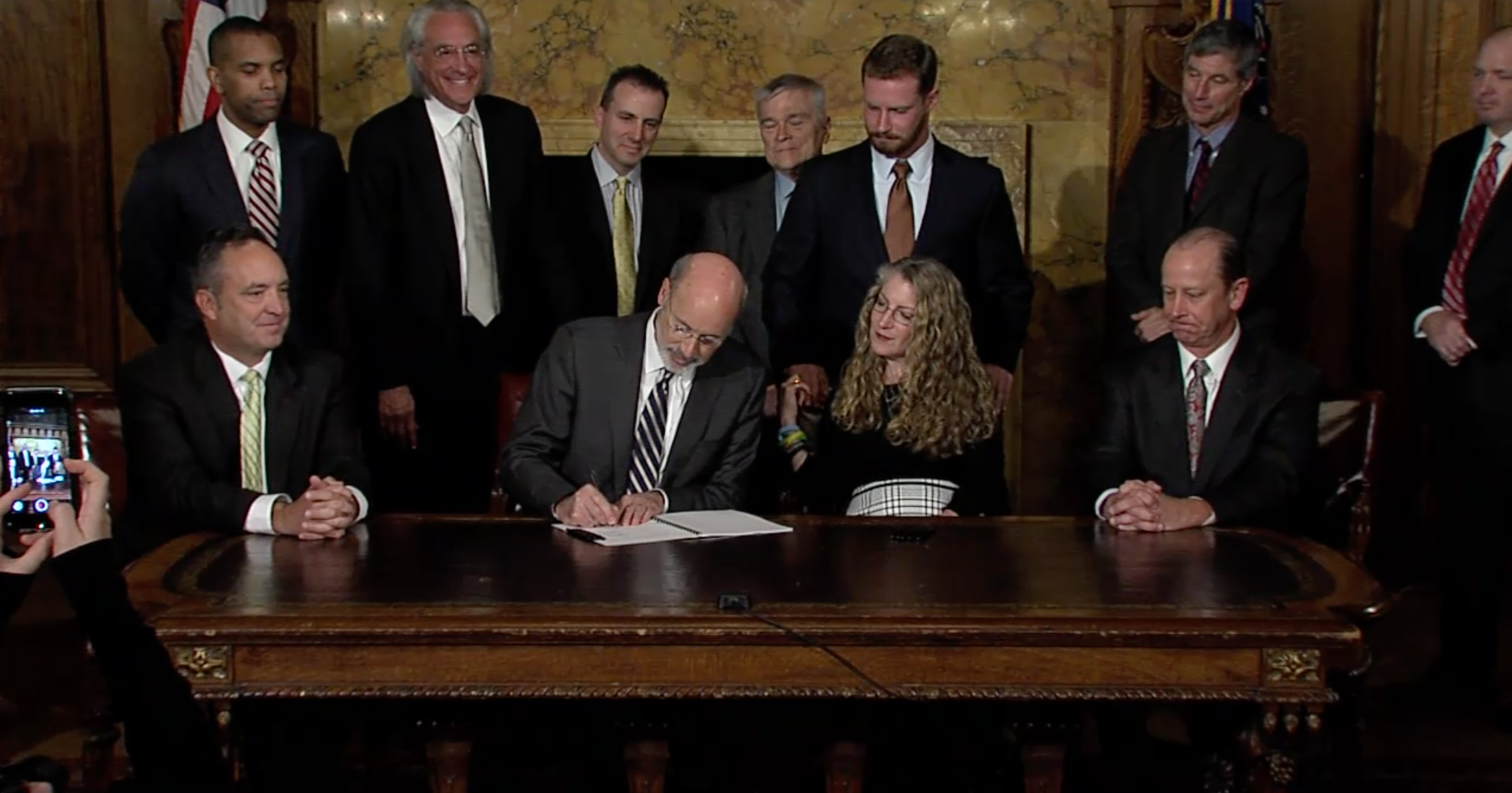 PHOTO: Pennsylvania Gov. Tom Wolf signs the anti-hazing law surrounded by lawmakers and the family of Tim Piazza.