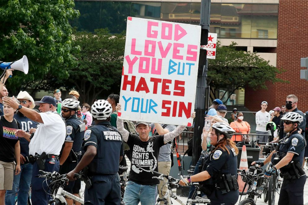 PHOTO: Anti-Pride protestors demonstrate behind a police line on June 12, 2021, in the Dupont Circle neighborhood of Washington, D.C. 