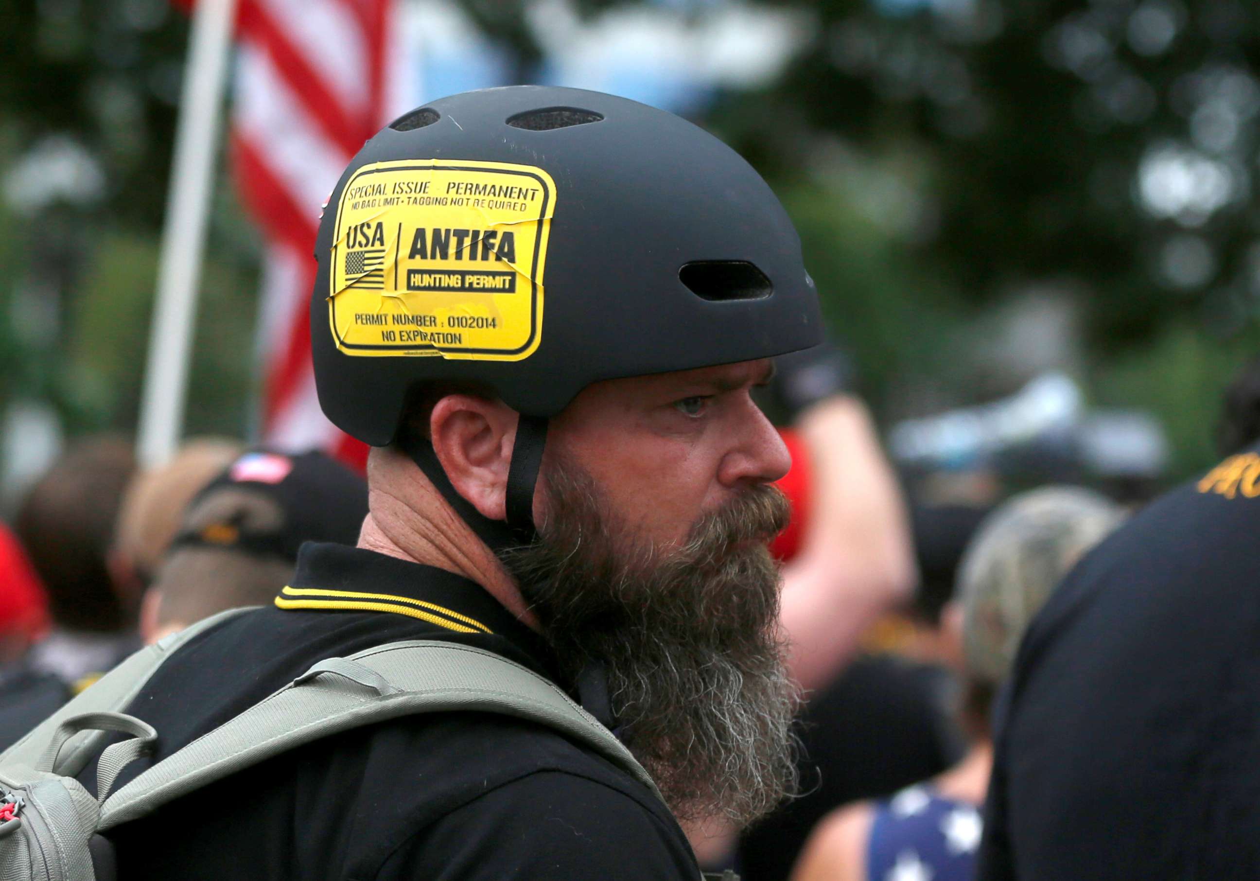 PHOTO: A man wears a sticker that says "Antifa Hunting Permit" at a Proud Boys rally in Portland, Ore., Aug. 17, 2019.