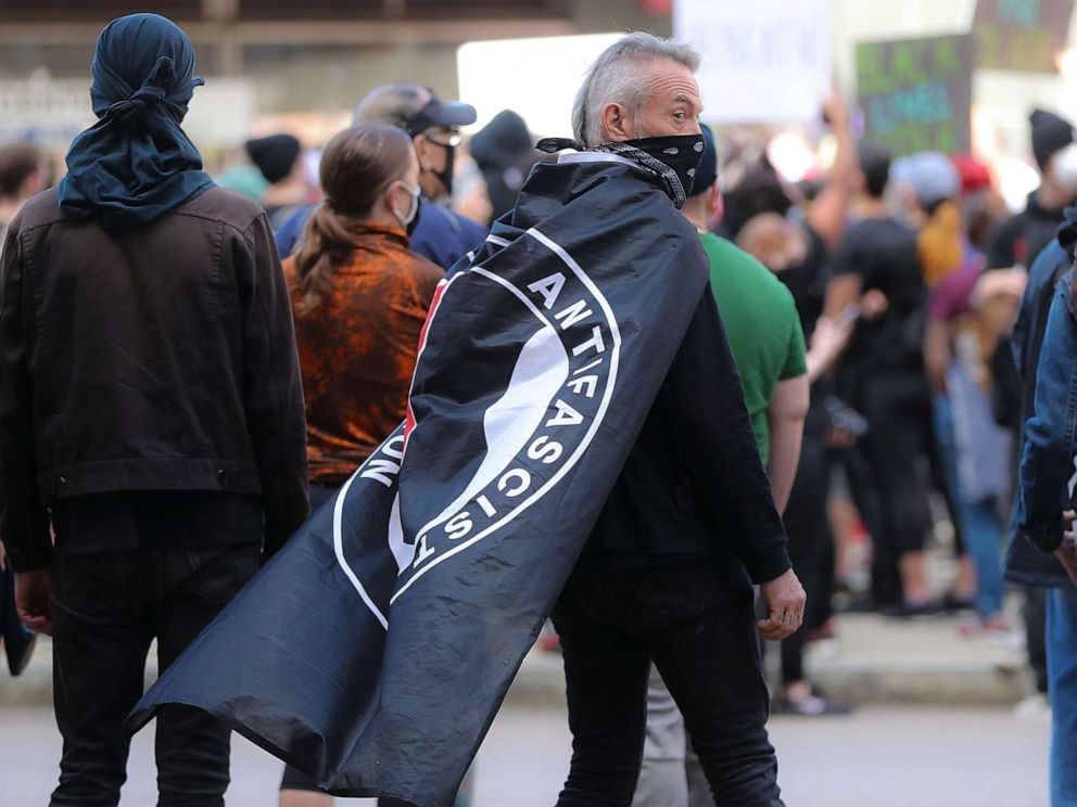 PHOTO: Hundreds of protesters gather at Government Center including a protester with an ANTIFA flag draped over his shoulders during a rally in Boston on May 31, 2020.