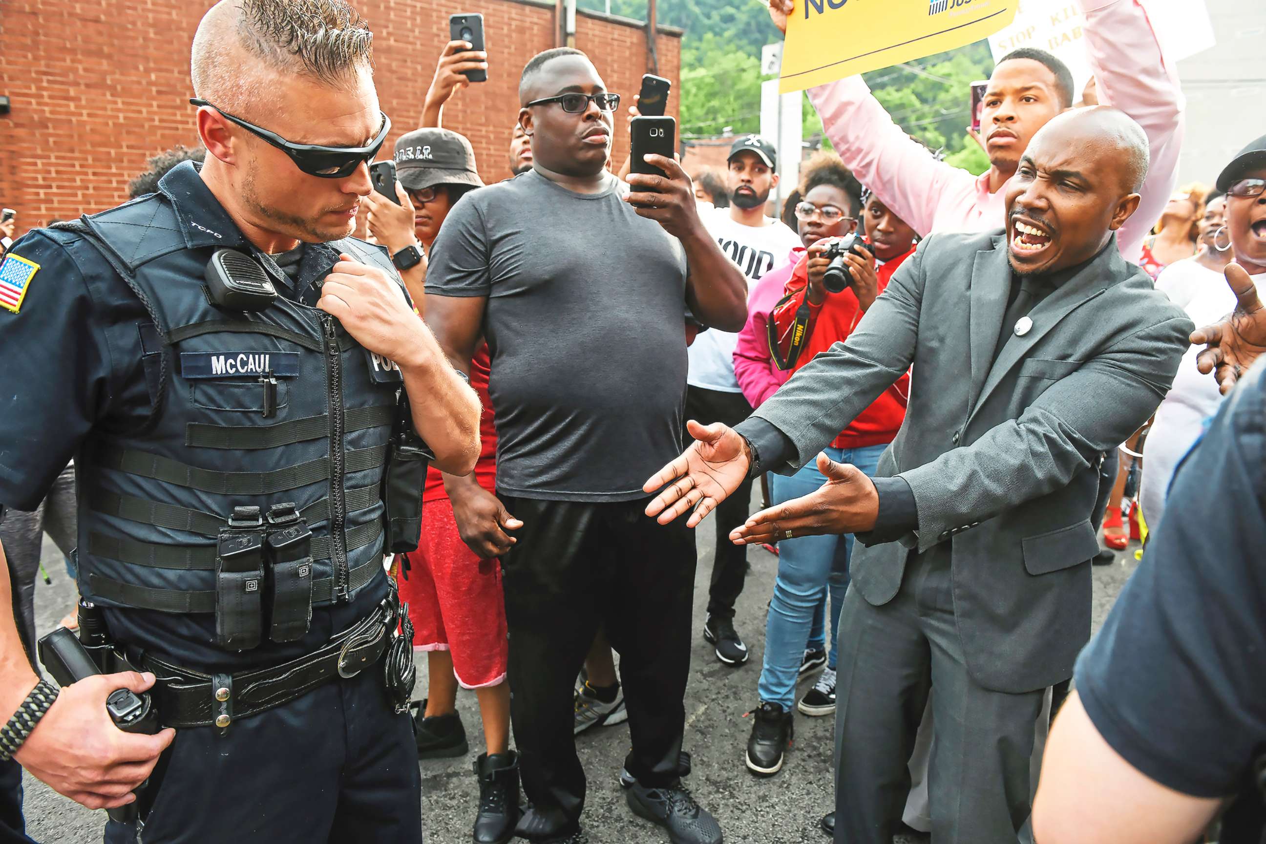 PHOTO: Leonard Hammonds II, of Penn Hills, right, points out that a Turtle Creek Police officer has his had on his weapon during a rally in East Pittsburgh, Pa., on June 20, 2018, at a protest regarding the shooting death of Antwon Rose.