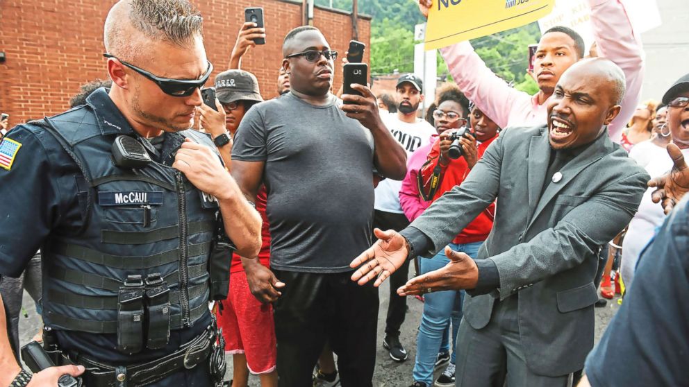 PHOTO: Leonard Hammonds II, of Penn Hills, right, points out that a Turtle Creek Police officer has his had on his weapon during a rally in East Pittsburgh, Pa., on June 20, 2018, at a protest regarding the shooting death of Antwon Rose.