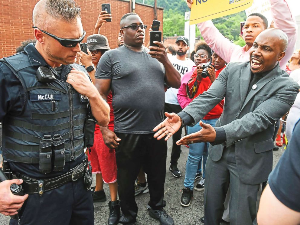 PHOTO: Leonard Hammonds II, of Penn Hills, right, points out that a Turtle Creek Police officer has his had on his weapon during a rally in East Pittsburgh, Pa., on June 20, 2018, at a protest regarding the shooting death of Antwon Rose.