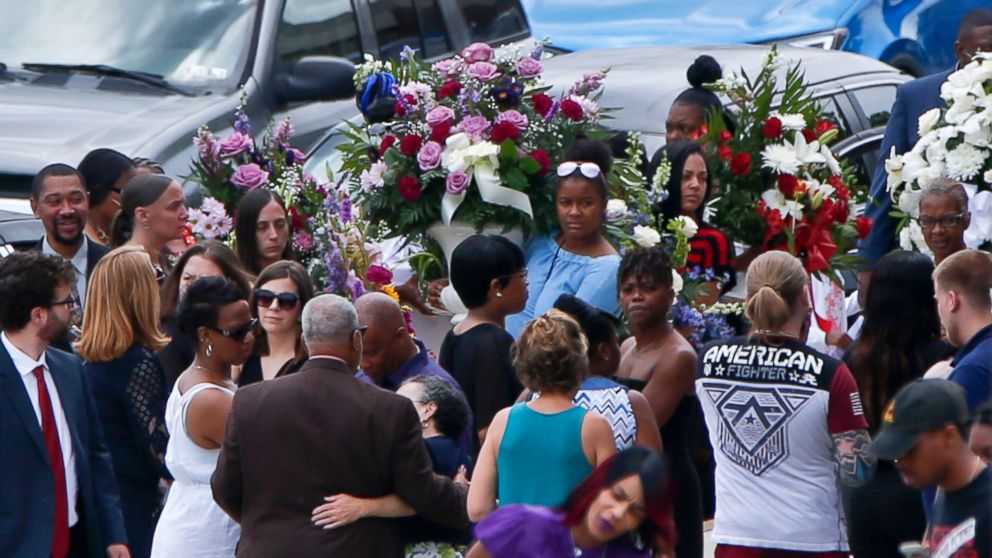 PHOTO: People carry flowers to the cars as they leave the funeral for Antwon Rose Jr., June 25, 2018, in Swissvale, Pa.