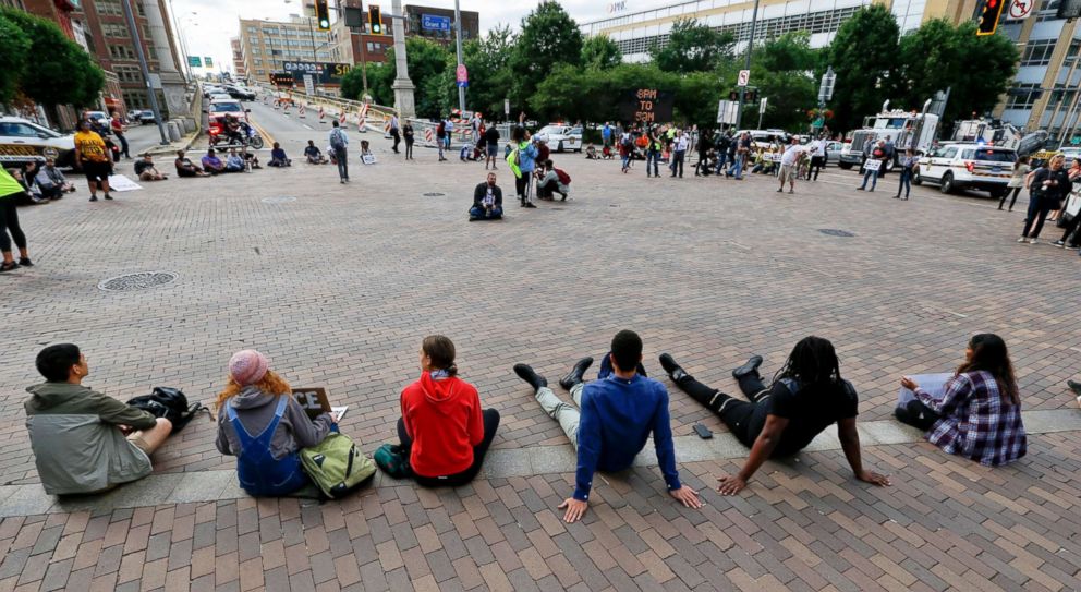 PHOTO: Marchers sit down at the intersection of Grant Street and the Boulevard of the Allies and stop traffic as they protest the shooting death of Antwon Rose Jr. on Tuesday, June 26, 2018, in Pittsburgh.