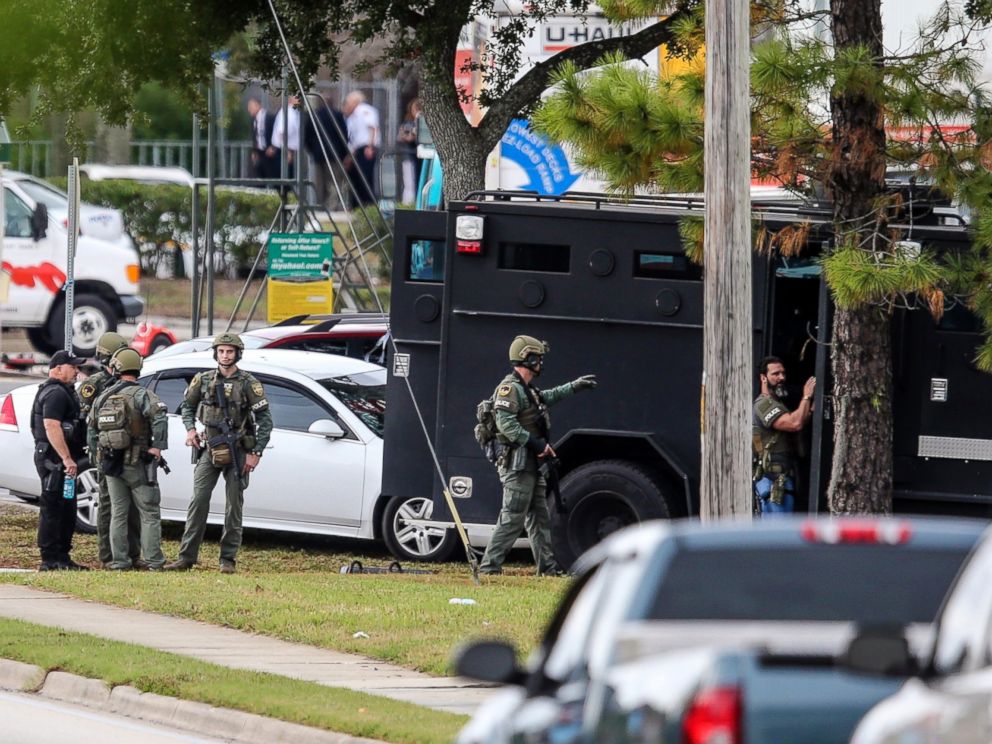 PHOTO: Law enforcement personnel gather near the Community First Credit Union bank, Thursday, Dec. 1, 2016, in Jacksonville, Fla., where authorities say a bank robber was holding several hostages.