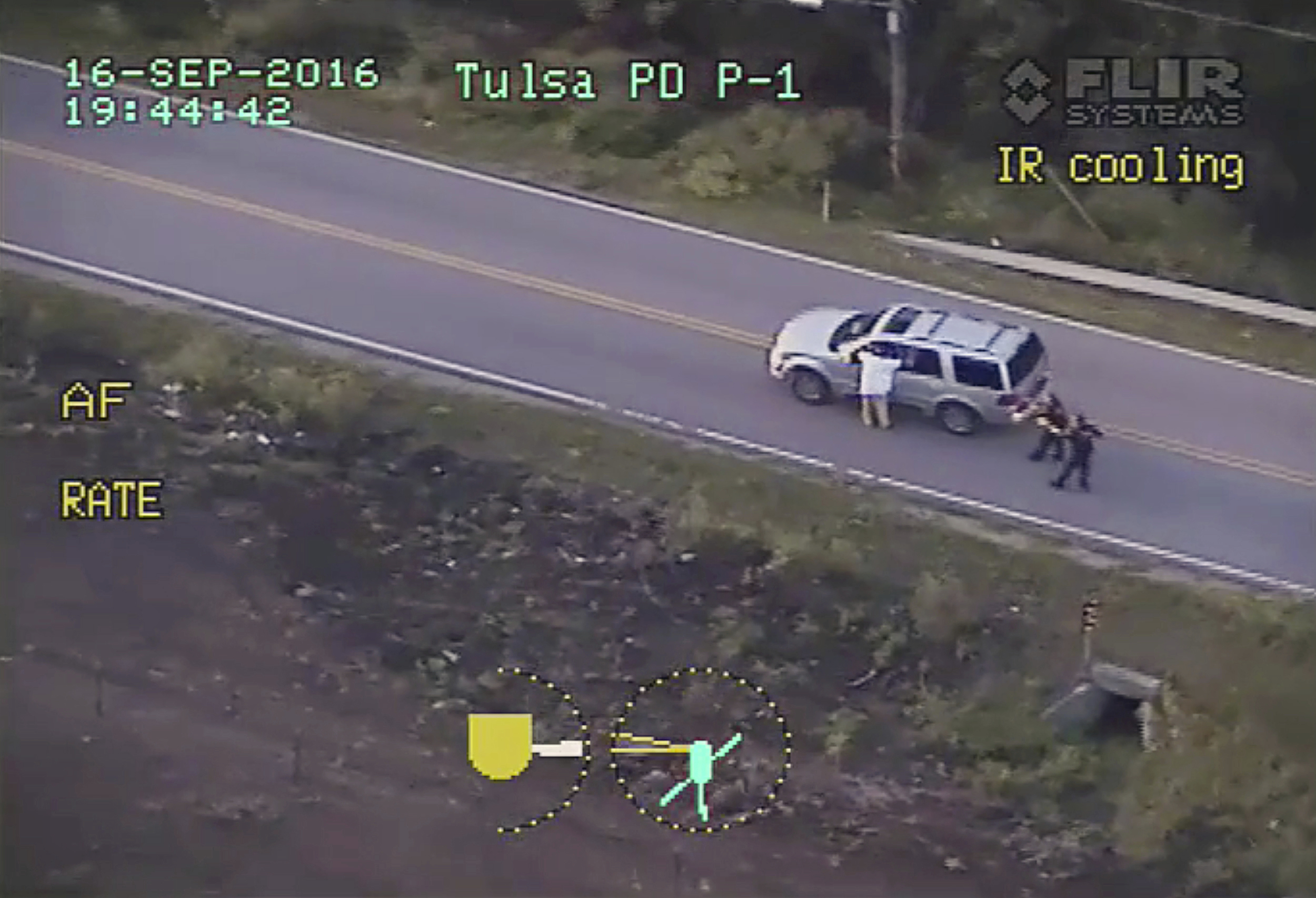 PHOTO: In this Sept. 16, 2016 image made from video provided by police, Terence Crutcher, left, with his arms held up, is pursued by police officers as he walks next to his stalled SUV before he was shot and killed by one of the officers in Tulsa, Okla.
