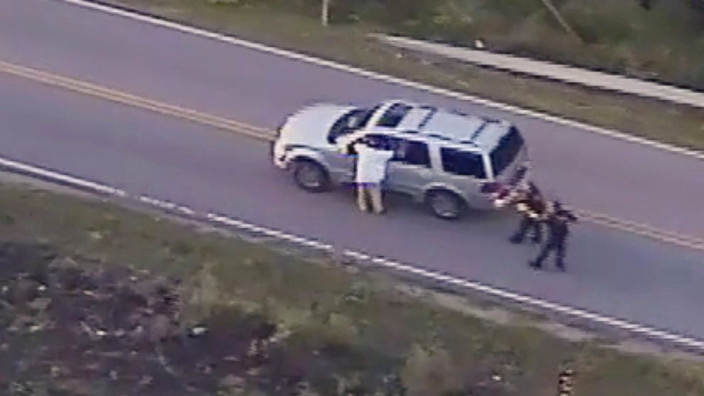 PHOTO: In this Sept. 16, 2016 image made from video provided by police, Terence Crutcher, left, with his arms held up, is pursued by police officers as he walks next to his stalled SUV before he was shot and killed by one of the officers in Tulsa, Okla.