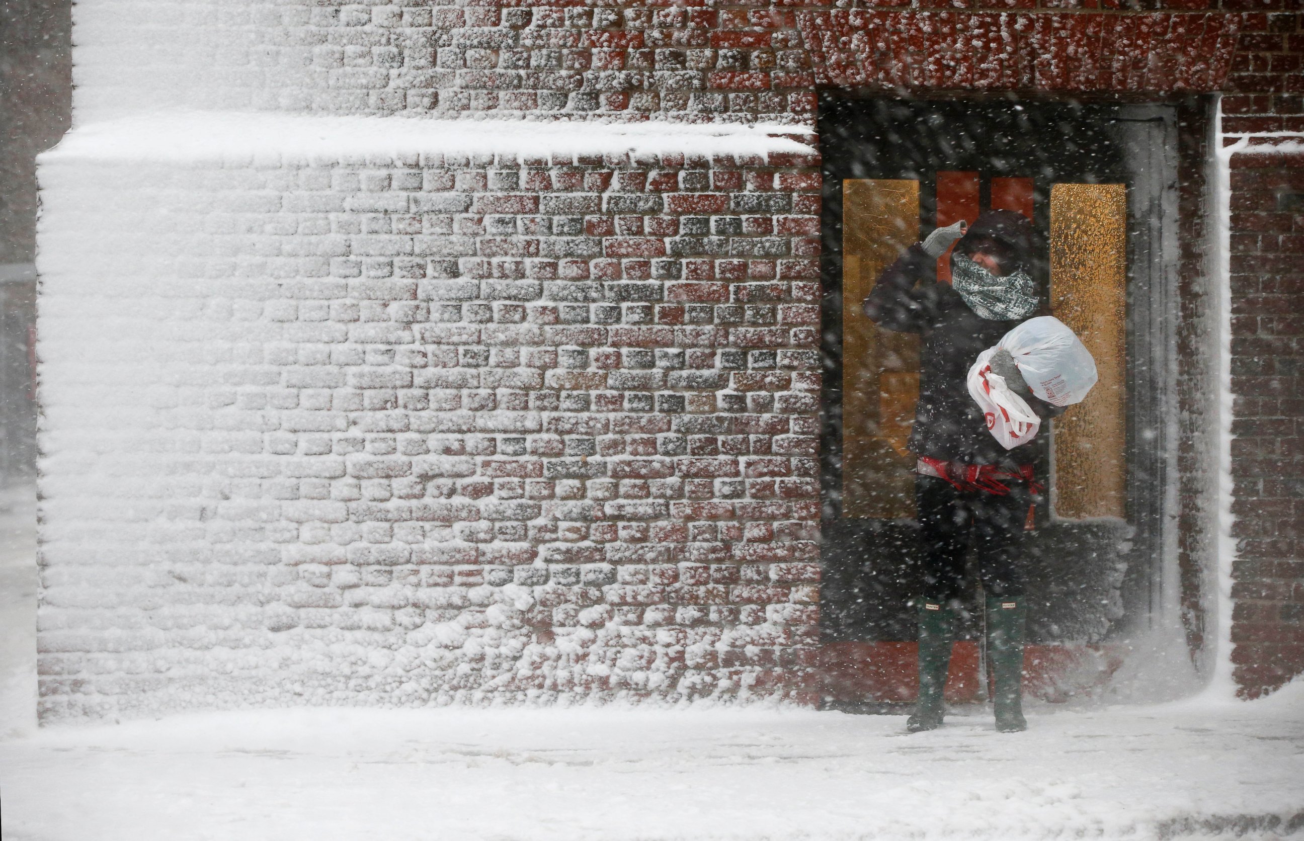 PHOTO: A person stands in the wind-driven snow during a winter storm, March 14, 2017, in Boston.