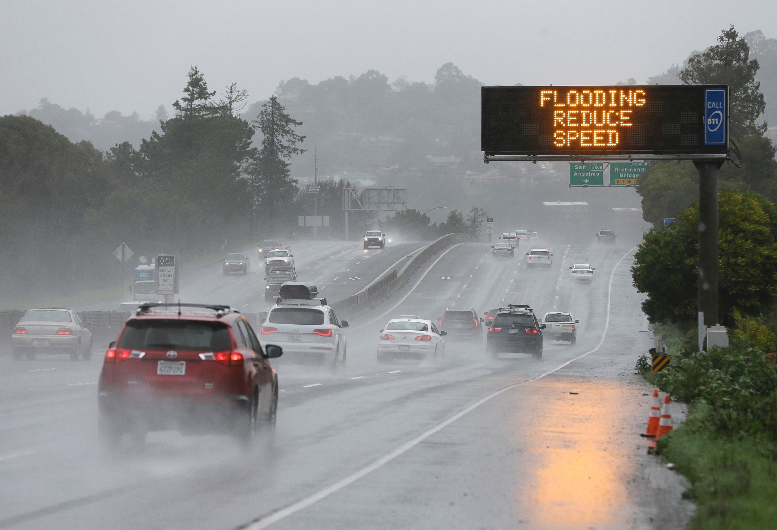 PHOTO: A sign warns motorists of flooding on northbound Highway 101, Feb. 20, 2017, in Corte Madera, Calif. 