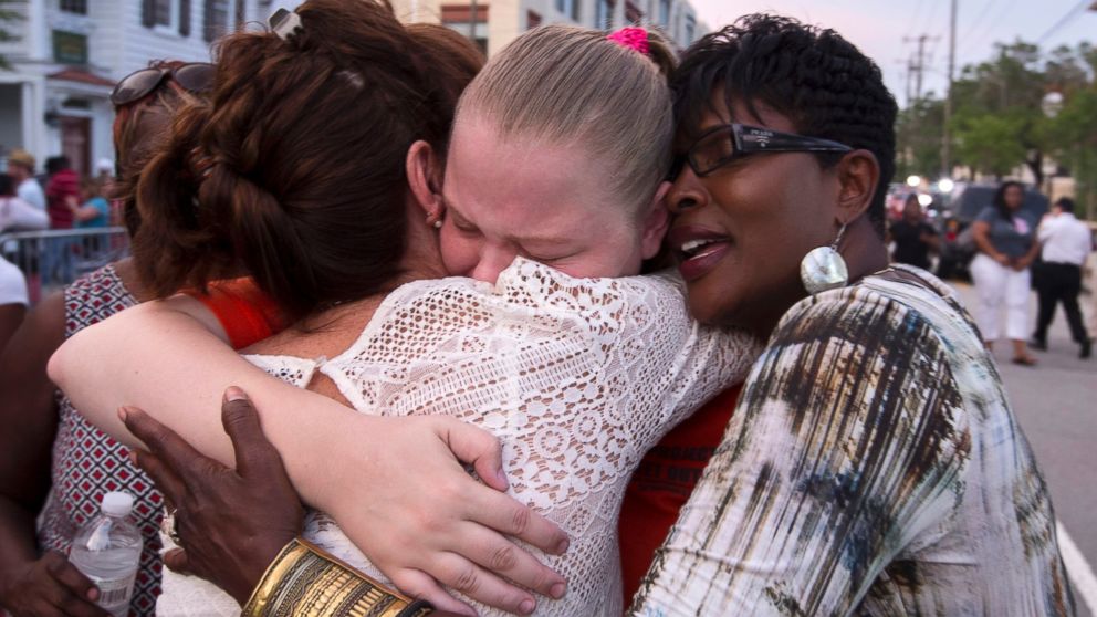 PHOTO: J. Denise Cromwell, left, hugs her daughter, Asia Cromwell, center, and a friend Sandy Teckledburg outside the Emanuel AME Church after a memorial in Charleston, S.C., June 19, 2015.