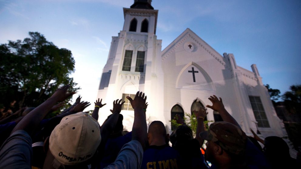 PHOTO: Men from Omega Psi Phi Fraternity Inc. lead a crowd of people in prayer outside the Emanuel AME Church in Charleston, S.C., June 19, 2015.