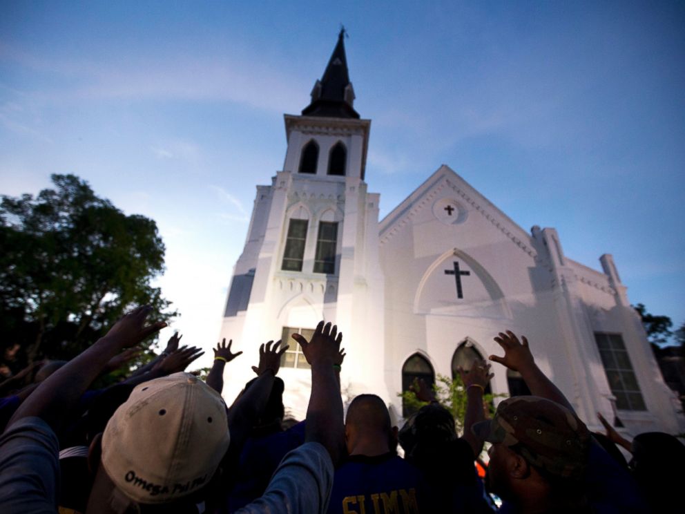 PHOTO: Men from Omega Psi Phi Fraternity Inc. lead a crowd of people in prayer outside the Emanuel AME Church in Charleston, S.C., June 19, 2015.