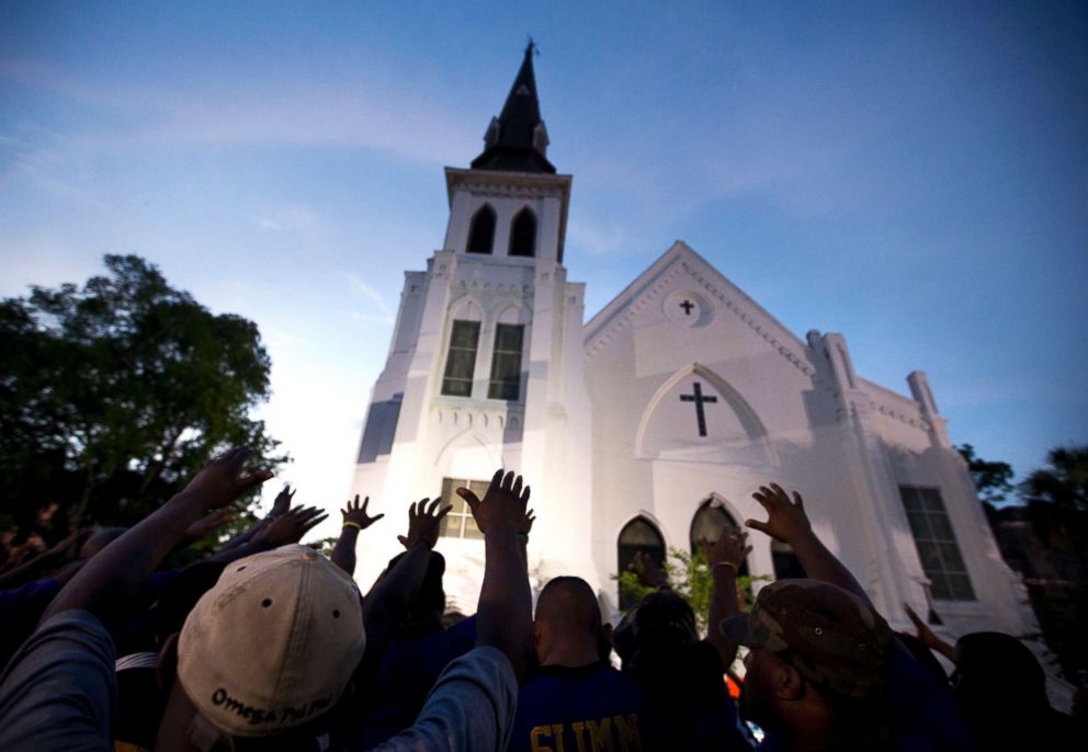 PHOTO: Men from Omega Psi Phi Fraternity Inc. lead a crowd of people in prayer outside the Emanuel AME Church in Charleston, S.C., June 19, 2015.