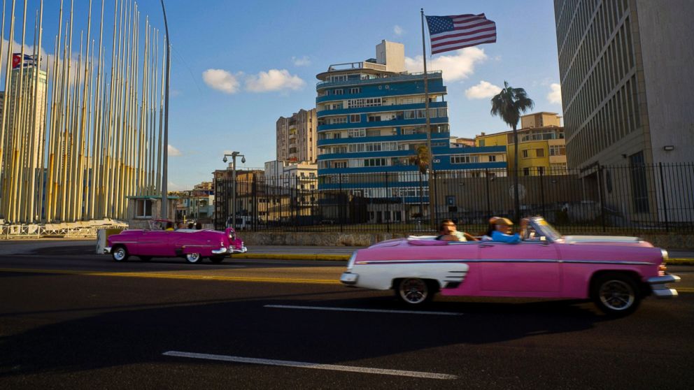 Tourists ride in classic American convertible cars past the United States embassy in Havana, Cuba, Jan. 12, 2017.  