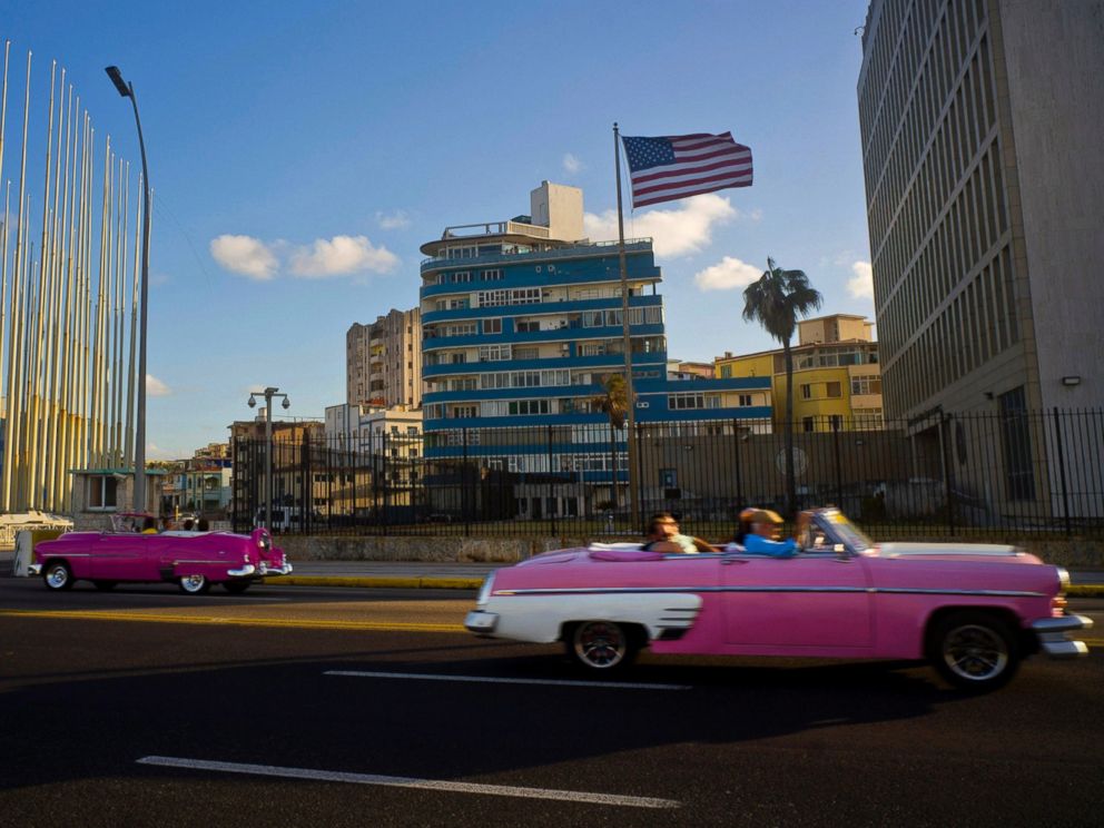 PHOTO: Tourists ride in classic American convertible cars past the United States embassy in Havana, Cuba, Jan. 12, 2017.