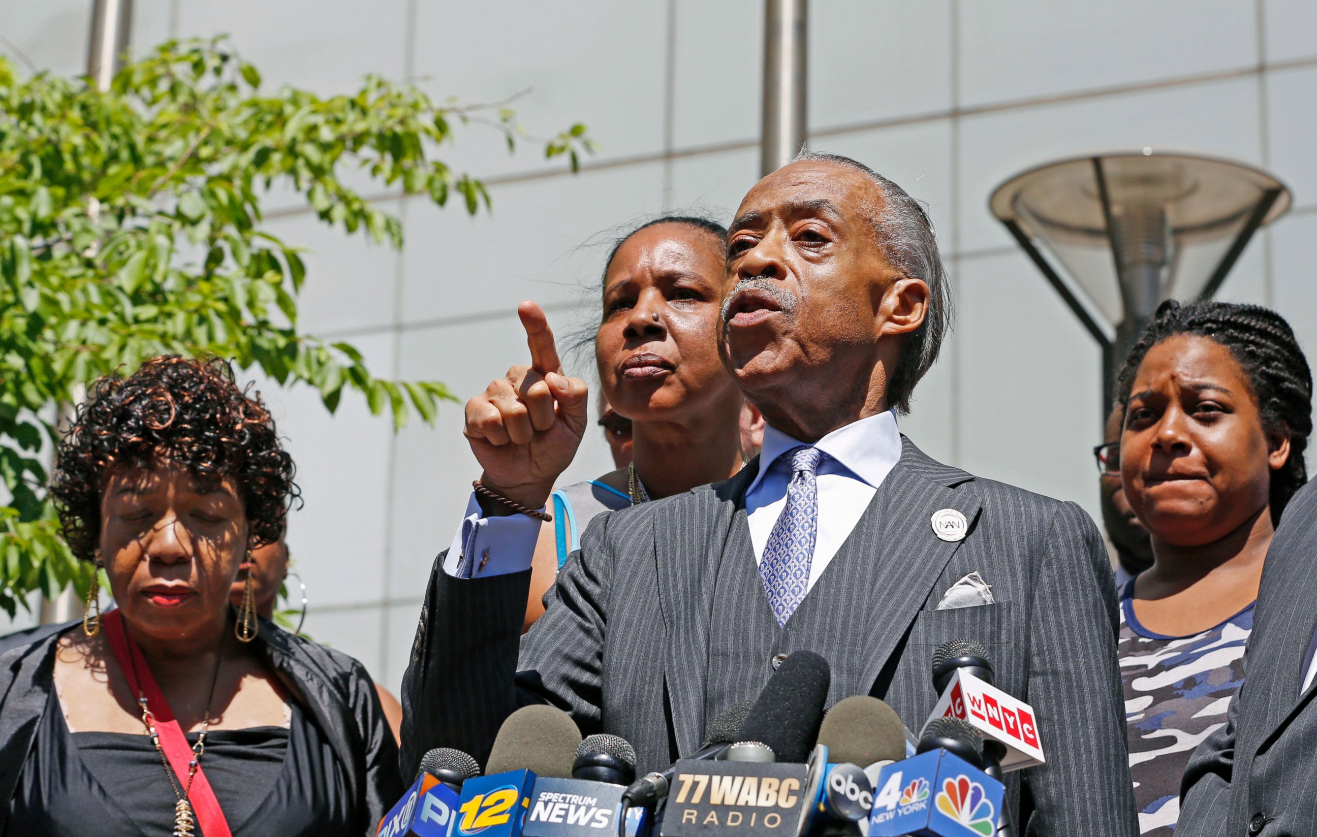 The Rev. Al Sharpton, second from right, gestures as he speaks to the media alongside members of Eric Garner's family, including Erica Garner, far right, after meeting with Department of Justice officials, Wednesday, June 21, 2017, in New York.