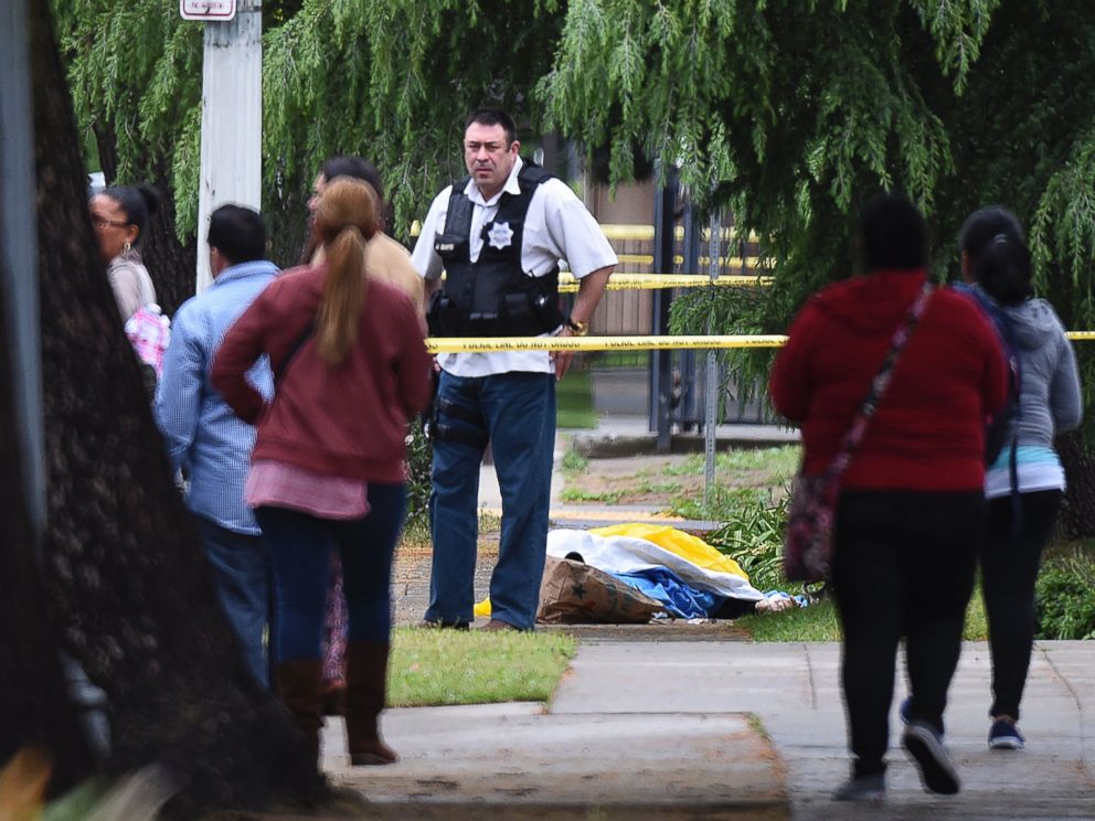 PHOTO: A Fresno police detective stands over the body of one of the three shooting victims, April 18, 2017 in Fresno, Calif.