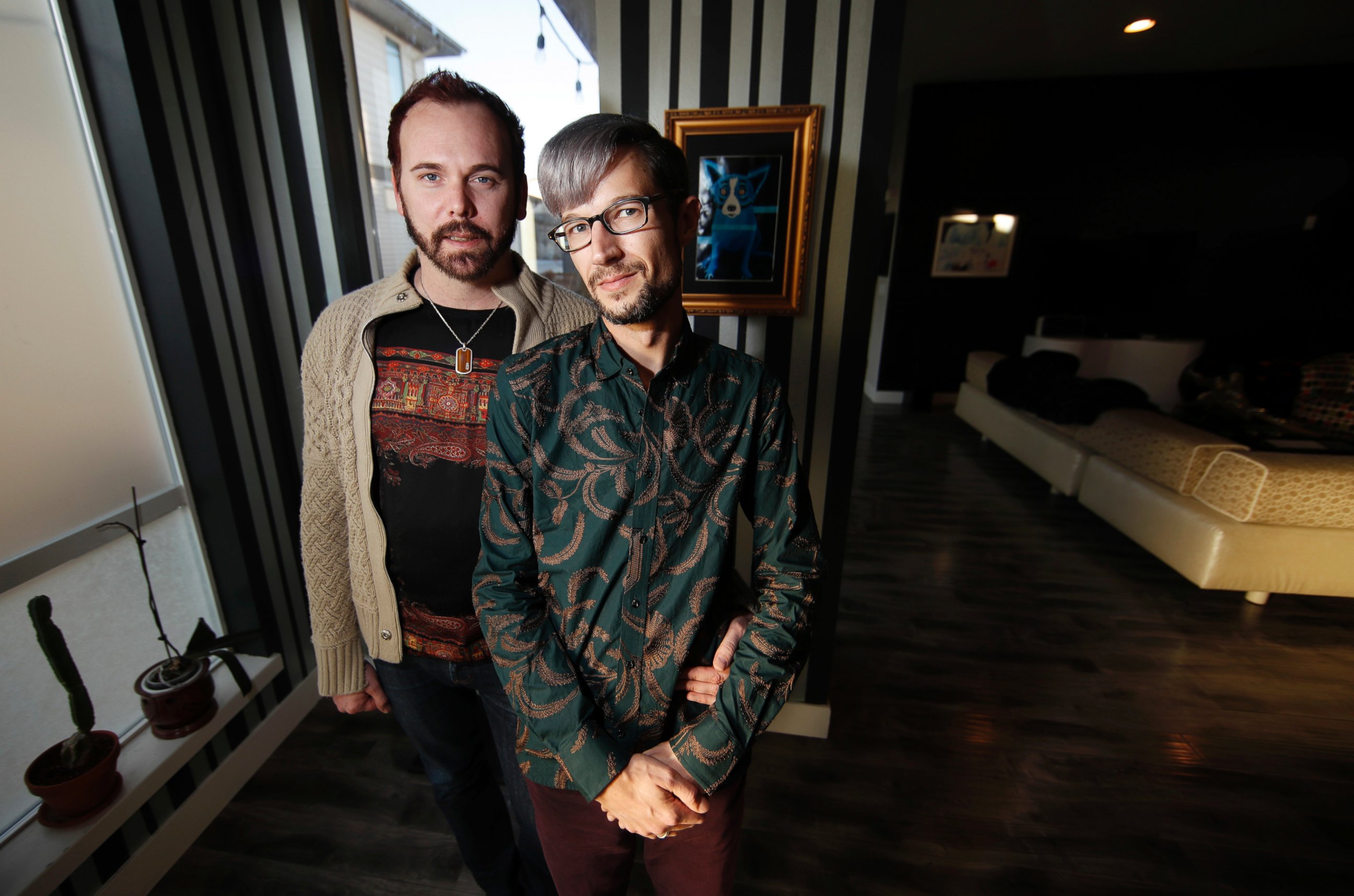 In this Tuesday, Nov. 28, 2017, photograph, Charlie Craig and David Mullins are shown in their home in Denver.