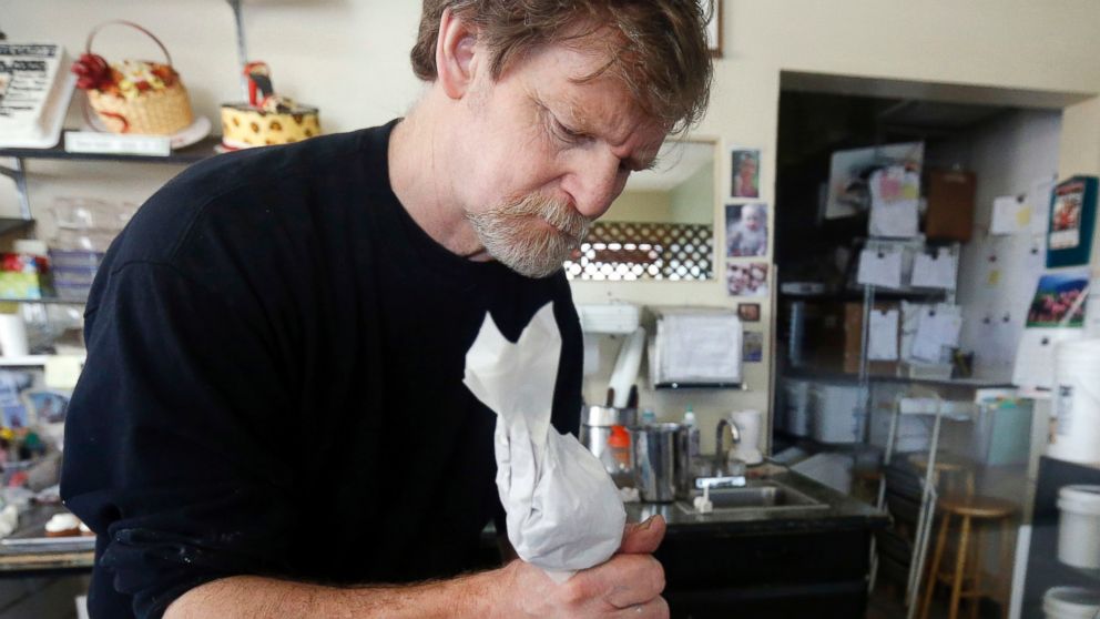 In this March 10, 2014, file photo, Masterpiece Cakeshop owner Jack Phillips decorates a cake inside his store in Lakewood, Colo.