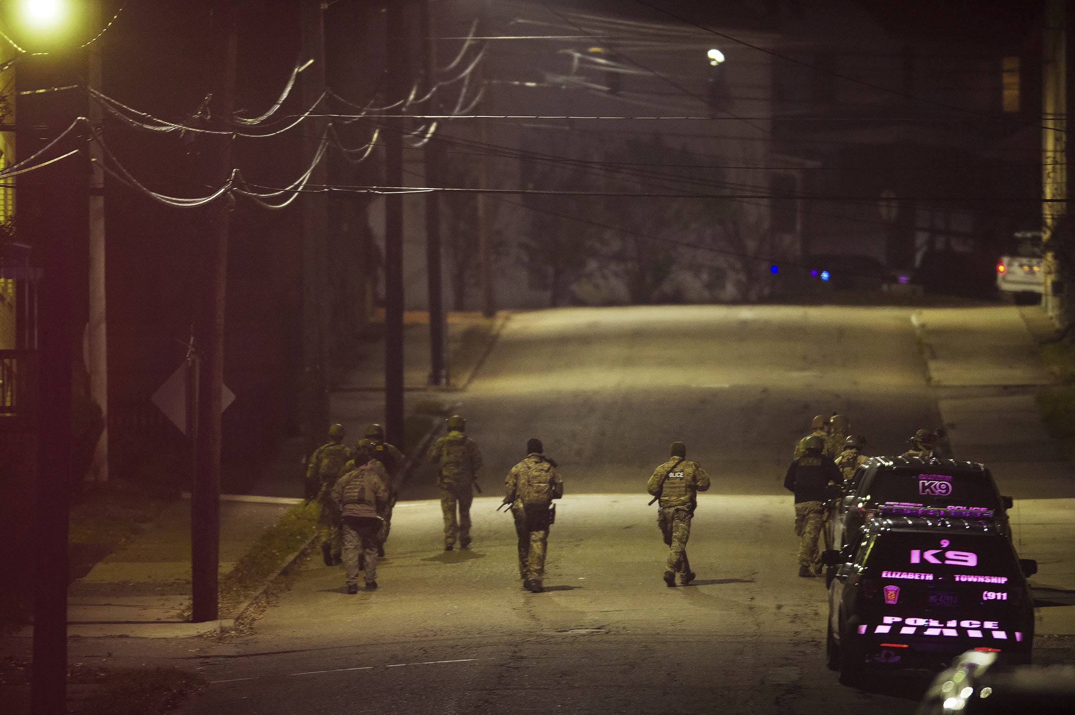 PHOTO: A SWAT team walks along a street in the neighborhood where a police officer was fatally shot Friday, Nov. 17, 2017, in New Kensington, Pa.